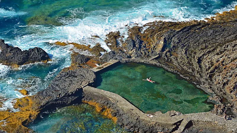 The island is home to natural volcanic rock pools protected from the powerful ocean currents 